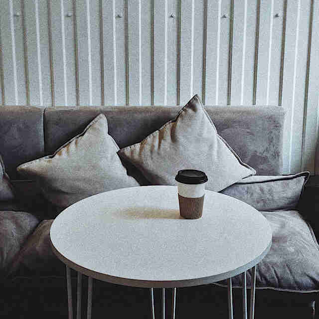 Grey sofa with white table